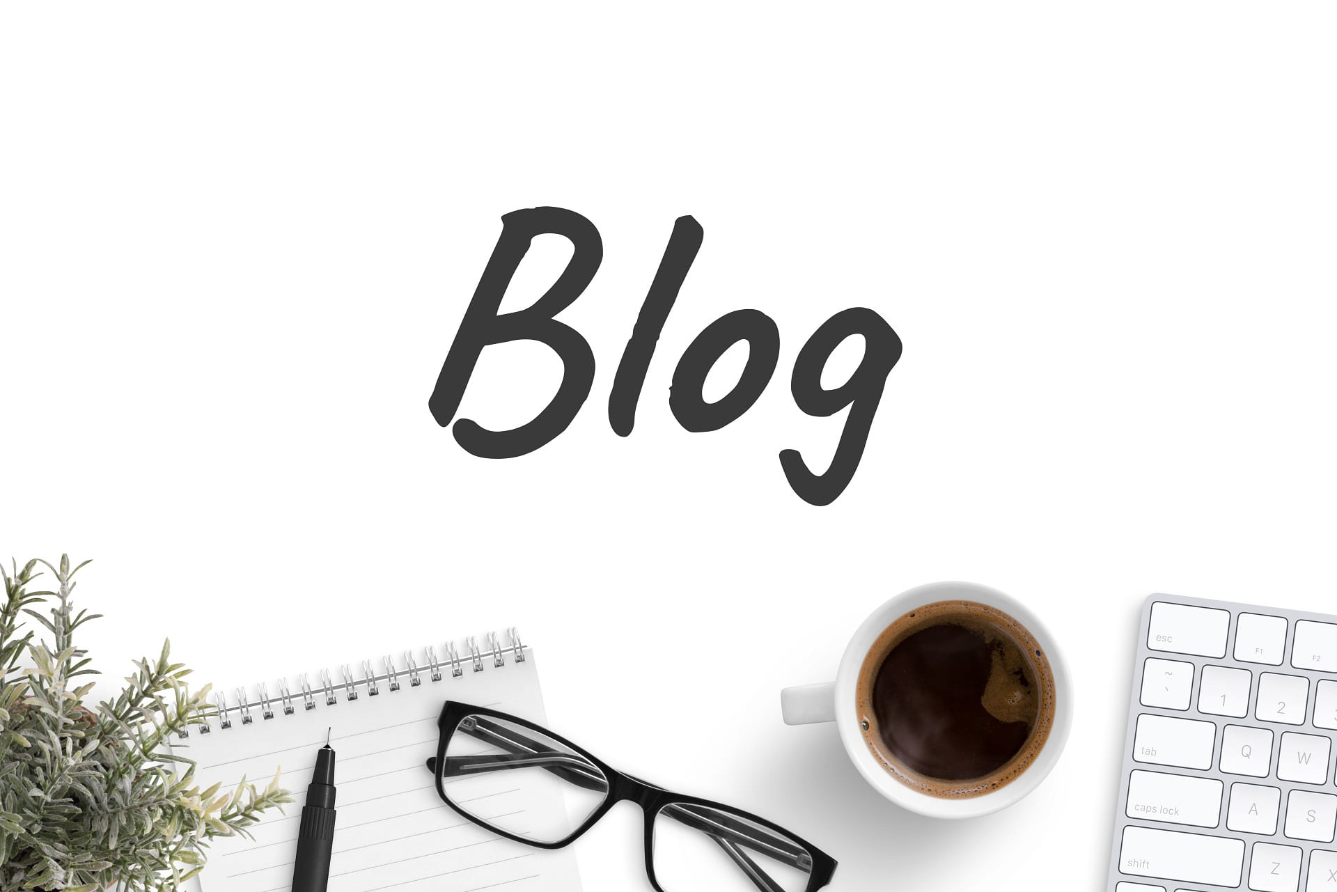 A notebook with the word 'Blog' written on the page, a pen and a coffee cup visible in the frame.